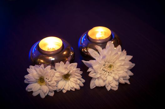An image of White flowers and candles on the table