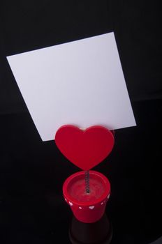 An image of red holder with heart and paper