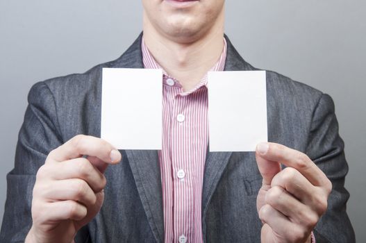 An image of businessmen holding blank card