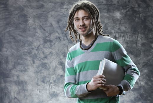 Portrait of smiling young student with books