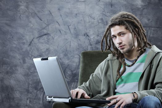 Young man student working with his laptop