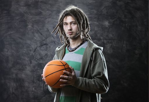 Portrait of young man with basketball