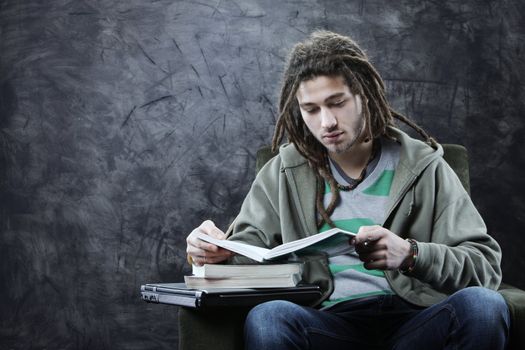 Portrait of young man student reading a book