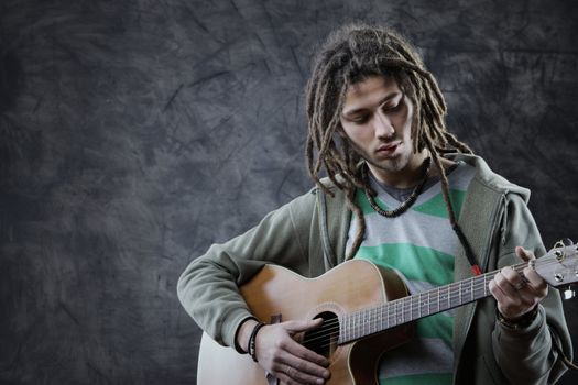 Young man playing acoustic guitar