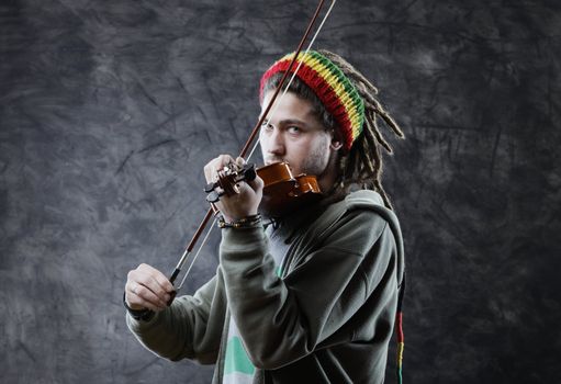Rasta man musician playing violin
