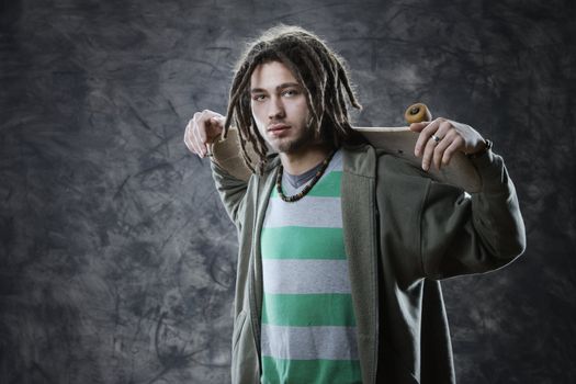 Portrait of young guy with a skateboard
