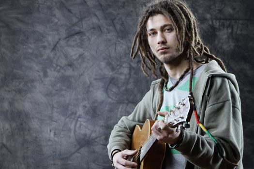 Young man playing acoustic guitar