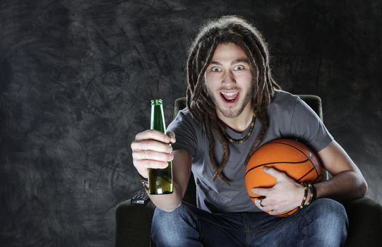 Happy young man watching sport on television