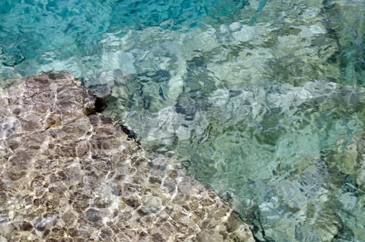 Rock under clear water at shore of Georgian Bay of Lake Huron Ontario