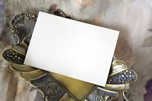 blank white card on golden tray