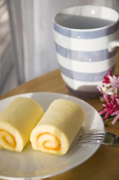 orange jam roll cake on table in the morning