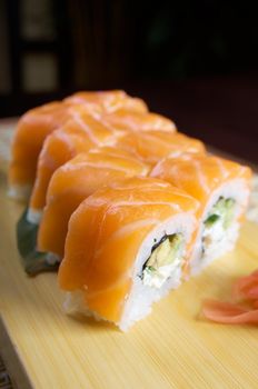 Uramaki. Philadelphia classic. Salmon, Philadelphia cheese, cucumber, avocado, tobiko. Japanese sushi