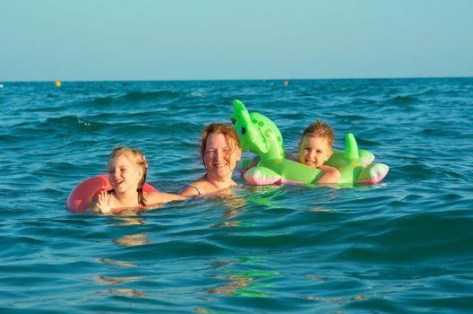 family in the waves on the sea beach