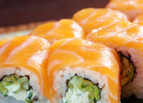 Uramaki. Philadelphia classic. Salmon, Philadelphia cheese, cucumber, avocado, tobiko. Japanese sushi