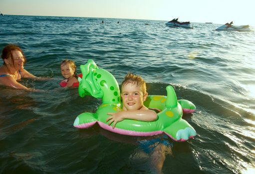 family in the waves on the sea beach