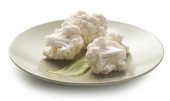 Four pieces of cauliflower with leaf on the cossack green plate