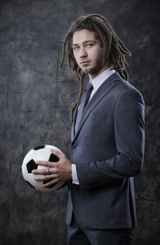 Portrait of a businessman with a soccer ball