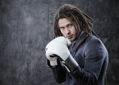 Businessman with boxe glove. Concept about the aggresivity of new business
