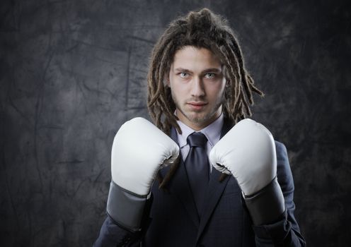 Businessman with boxe glove. Concept about the aggresivity of new business