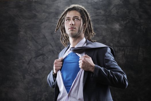 Superhero dressed in suit, shirt and tie pulling open shirt 