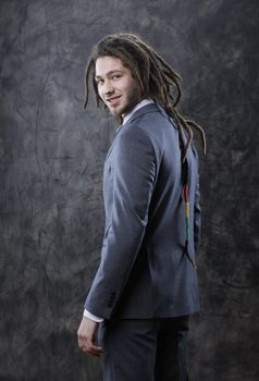 Portrait of positive well-dressed young businessman