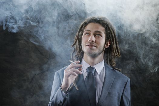 Rastafarian businessman smoking marijuana