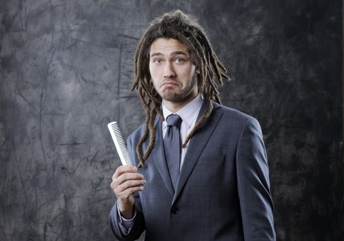 Portrait of a rastafarian man with comb