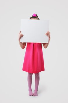 A little girl holds a blank sign, ready for your text