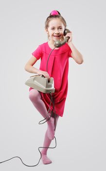 Cute young girls talking on vintage phone