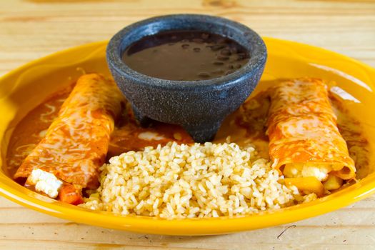 Enchiladas and rice and beans at a Mexican restaurant serving authentic cuisine.