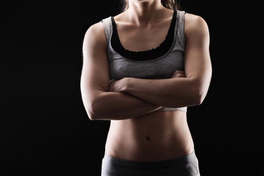 Young muscular woman in exercise clothing