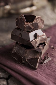 Stack of dark chocolate pieces on a napkin