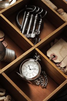 close up of old objects in a drawer with compartments