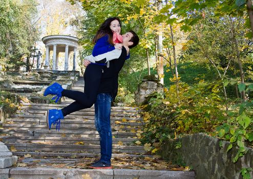 Happy smiling embracing couple being together in nature