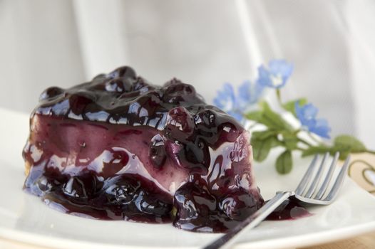 close up blueberry topping on cheesecake