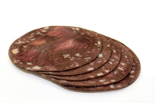 some slices of tongue sausage on white background