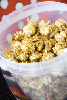 close up caramel popcorn in plastic bucket