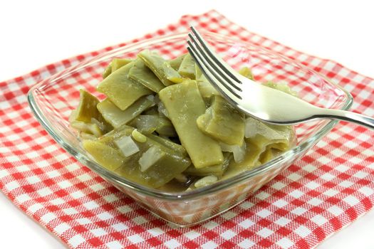 a bowl of bean salad on a white background