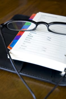 eyeglasses put on page of personal organizer
