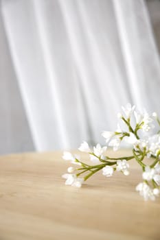 pretty white artificial flowers on table