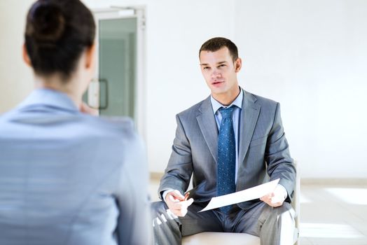 Businessman talking to a woman for a job, interviewing