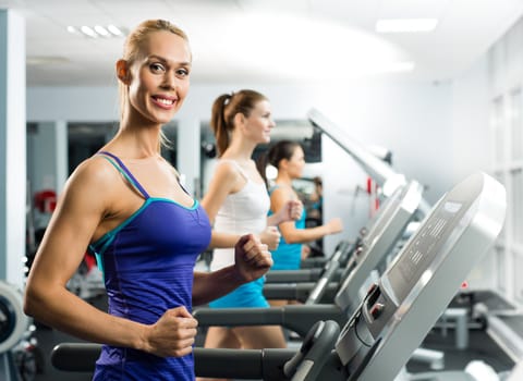 young women running on a treadmill, exercise at the fitness club