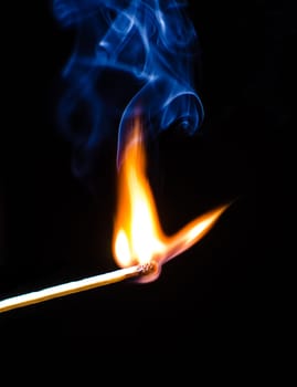 Match ignition with smoke over black background