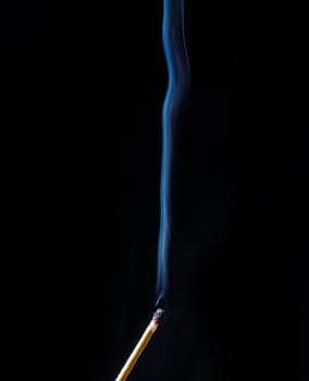 Fireless match and smoke wave on black background