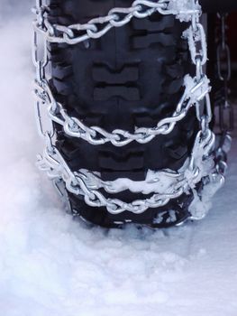 Snow chains outside at a wheel in winter