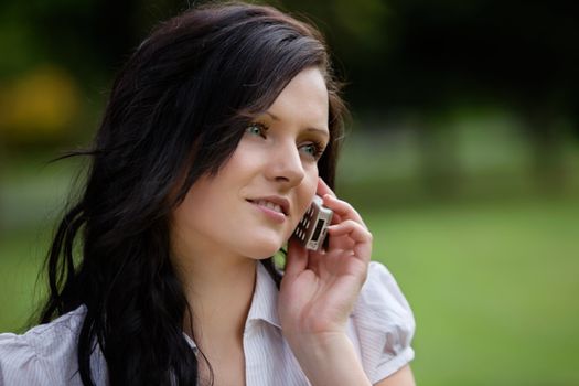 Pretty young woman talking on cell phone