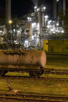 Obsolete wagon in front of an industry building