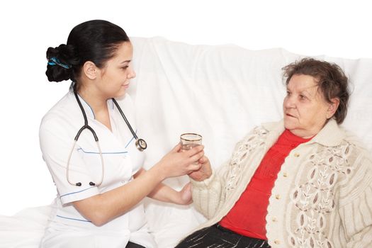 Senior woman is visited by her doctor. Medicine