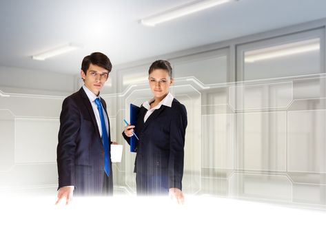 Young busuinesspeople standing against high-tech image background