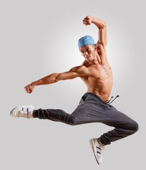 young man in a blue cap dancing hip hop